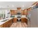 Bright kitchen with stainless steel appliances, quartz countertops, and stylish wood cabinetry at 702 Great Eno Path, Hillsborough, NC 27278