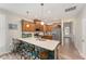 Modern kitchen with stainless steel appliances, large island with bar seating, and wood cabinets at 702 Great Eno Path, Hillsborough, NC 27278