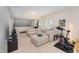 Comfortable living room featuring a sectional sofa and exercise bike at 702 Great Eno Path, Hillsborough, NC 27278