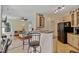 Open kitchen flows to living area, featuring granite counters, stainless appliances, and breakfast bar seating at 715 Southshore Pkwy, Durham, NC 27703