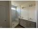Modern bathroom with a dual sink vanity, a large frameless mirror, and a luxurious shower with a bench at 720 Hipwood Dr, Zebulon, NC 27597