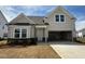 Charming new construction home with light siding, a covered front porch, and a spacious two-car garage at 720 Hipwood Dr, Zebulon, NC 27597