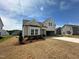 Beautiful new construction home with light siding, a covered porch, and a convenient two-car garage at 720 Hipwood Dr, Zebulon, NC 27597
