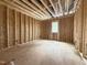 Unfinished bedroom with exposed rafters and a single window for natural light and ventilation at 7429 Wexford Woods Ln, Wake Forest, NC 27587