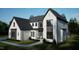 New construction home with light grey brick, and white siding with grey accents and black window frames at 7429 Wexford Woods Ln, Wake Forest, NC 27587