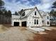 New construction home with black window frames, grey shingles, and covered in Exeter guard house wrap and a garage at 7429 Wexford Woods Ln, Wake Forest, NC 27587