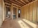 Open-concept interior displaying exposed wood framing, multiple doorways, and potential for personalized design at 7429 Wexford Woods Ln, Wake Forest, NC 27587