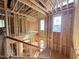 Striking unfinished two-story interior with exposed wood framing, large windows, and natural light throughout at 7429 Wexford Woods Ln, Wake Forest, NC 27587