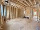 Unfinished room featuring exposed rafters, plywood flooring and multiple window frames for natural light at 7429 Wexford Woods Ln, Wake Forest, NC 27587