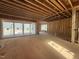 Spacious living room under construction with sliding glass doors and natural light at 7429 Wexford Woods Ln, Wake Forest, NC 27587