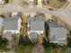 An aerial view shows backyard and neighborhood with well-maintained yards and mature trees at 749 Lake Artesia Ln, Fuquay Varina, NC 27526