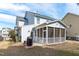 Backyard with a patio, screened porch, and lush lawn, great for outdoor living at 749 Lake Artesia Ln, Fuquay Varina, NC 27526