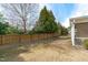 Private backyard bordered by a wood fence and mature trees for added seclusion at 749 Lake Artesia Ln, Fuquay Varina, NC 27526