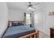 Bedroom featuring a wood-framed bed with blue bedding and a closet for storage at 749 Lake Artesia Ln, Fuquay Varina, NC 27526