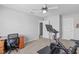 Functional bedroom equipped with a desk, chair, and Peloton bike for at-home exercise and productivity at 749 Lake Artesia Ln, Fuquay Varina, NC 27526