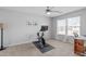 Bright bedroom featuring neutral walls and a stationary bike for at-home workouts at 749 Lake Artesia Ln, Fuquay Varina, NC 27526