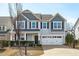 Charming two-story home with a two car garage and well-manicured landscaping at 749 Lake Artesia Ln, Fuquay Varina, NC 27526