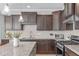 Well-appointed kitchen with stainless steel appliances and a granite topped island at 749 Lake Artesia Ln, Fuquay Varina, NC 27526