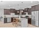 Gourmet kitchen with granite countertops, stainless steel appliances, and barstool seating at 749 Lake Artesia Ln, Fuquay Varina, NC 27526