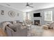 Spacious living room with a cozy fireplace and plenty of natural light at 749 Lake Artesia Ln, Fuquay Varina, NC 27526
