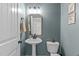 Stylish half-bathroom with modern fixtures and calming wall color at 749 Lake Artesia Ln, Fuquay Varina, NC 27526