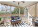 Cozy screened porch with comfortable seating and views of the backyard at 749 Lake Artesia Ln, Fuquay Varina, NC 27526
