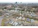 Aerial view of neighborhood featuring homes, streets, and a skyline backdrop at 847 Estes St, Durham, NC 27701