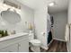 Bathroom with a white vanity, new hardware, and a shower and tub with a curtain at 847 Estes St, Durham, NC 27701
