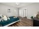 Bedroom with wood-look floors, neutral walls, and white doors with modern silver hardware at 847 Estes St, Durham, NC 27701