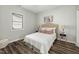 Bedroom with a queen bed, wood-look flooring, and neutral paint at 847 Estes St, Durham, NC 27701