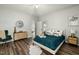 Comfortable bedroom features contemporary decor, a ceiling fan, and wood-look flooring at 847 Estes St, Durham, NC 27701