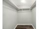 Walk-in closet features white walls, wood-look floors, and a clothing rack at 847 Estes St, Durham, NC 27701