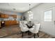 Bright dining area adjacent to the kitchen, featuring a stylish glass table and hardwood flooring at 847 Estes St, Durham, NC 27701