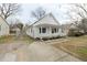 Exterior view showcasing the home's fenced yard and updated driveway that leads to the cozy front porch at 847 Estes St, Durham, NC 27701