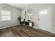 Bright living room featuring modern decor, laminate floors, and a well-lit entry door at 847 Estes St, Durham, NC 27701