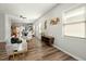 Spacious living room with neutral walls, laminate flooring, and views into the dining area at 847 Estes St, Durham, NC 27701