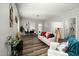 Open-concept living room with modern decor, neutral colors, and laminate floors at 847 Estes St, Durham, NC 27701
