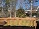 Spacious backyard deck with wooden railing, perfect for outdoor entertaining or enjoying the serene, wooded view at 100 Sandy Hook Way, Cary, NC 27513