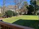 Expansive backyard view with mature trees and lush lawn, creating a private and tranquil outdoor space at 100 Sandy Hook Way, Cary, NC 27513