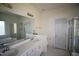 Bathroom with dual sinks, framed mirror, and walk-in shower at 100 Sandy Hook Way, Cary, NC 27513