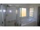 Bright bathroom featuring a glass shower and soaking tub at 100 Sandy Hook Way, Cary, NC 27513