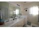 Bathroom featuring dual sinks, a framed mirror, a shower and toilet at 100 Sandy Hook Way, Cary, NC 27513
