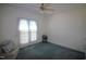 Bedroom with a large window, ceiling fan, and a sitting area at 100 Sandy Hook Way, Cary, NC 27513