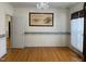 Bright dining room with hardwood floors, chandelier, decorative wallpaper border, and large window with curtain at 100 Sandy Hook Way, Cary, NC 27513