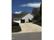 Charming home featuring an attached two-car garage and well-maintained landscaping at 100 Sandy Hook Way, Cary, NC 27513