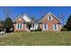 Charming brick home with a well-maintained lawn, blue shutters, and inviting curb appeal on a sunny day at 100 Sandy Hook Way, Cary, NC 27513