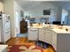 Open kitchen floor plan boasts stainless steel appliances, hardwood floors, and an eat-in breakfast bar at 100 Sandy Hook Way, Cary, NC 27513