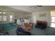 Open-concept living room featuring vaulted ceilings, ceiling fan and adjacent kitchen with a breakfast bar at 100 Sandy Hook Way, Cary, NC 27513