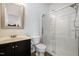 Clean bathroom features a sink with dark wood cabinet, toilet, and glass door shower at 1008 Scotch Pine Way, Mebane, NC 27302