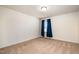 This bedroom features neutral walls, carpet, and blue curtains over the window at 1008 Scotch Pine Way, Mebane, NC 27302